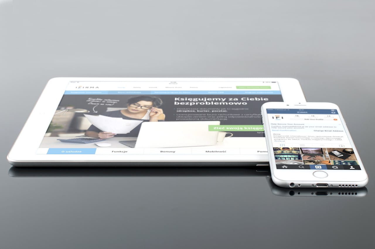 about-07 Modern tablet and smartphone displaying web content on a reflective surface, highlighting technology and connectivity.