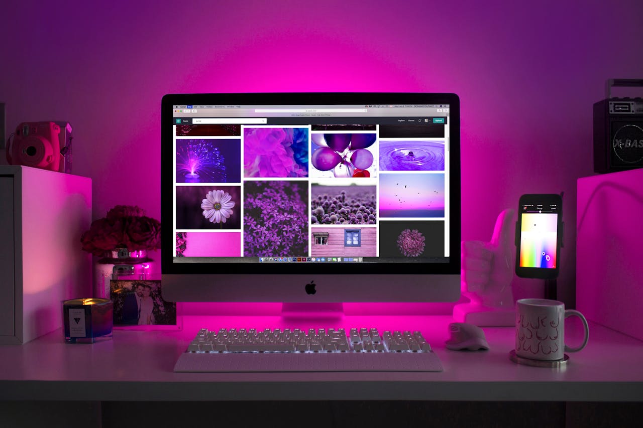 about-01 Modern desk setup with neon lighting and a desktop computer displaying colorful images.