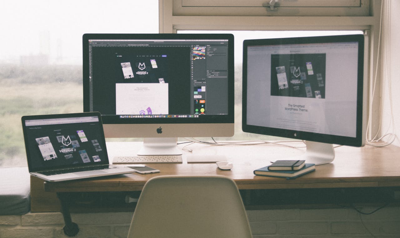 about-06 Stylish and efficient workspace with multiple monitors, laptop, and smartphone, showcasing a web design project.